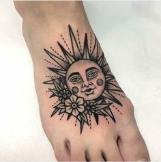 a foot with a sun and flower tattoo design on it's side, next to a person's toe