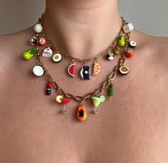 a woman wearing a necklace with charms on it