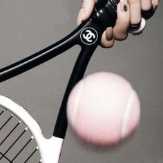 a person holding a tennis racquet and hitting a ball with their racket