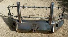 a close up of a metal object with barbed wire on it's sides and two holes in the middle