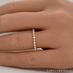 a woman's hand with a diamond ring on it