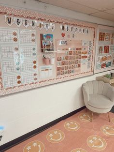 a room with a chair, desk and calendars on the wall