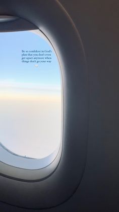 an airplane window looking out at the sky