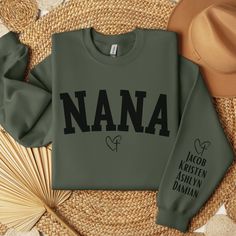 🔥This Personalized Christian Nana sweatshirt with grandkids names on sleeve is the perfect crewneck to show off your Faith Based Nana apparel in style. Can also be the perfect birthday gift, Mother's Day Gift or Christmas Gift for that special someone in your life that loves Faith Based Christian apparel. Personalization: Type in the names that you would like printed on the sleeve of the sweatshirt. Example: Jacob, Kristen, Ashlyn, Damian 🔥- Unisex Gildan 18000 crewneck sweatshirt - Made from 50% polyester & 50% cotton - Collar is ribbed knit, so it retains its shape even after washing 🔥Care Instructions - Machine wash in cold water  - Turn item inside out - Tumble dry low - Hang for best care - Do not iron design - Do not use bleach 🔥Production/Shipping Time Production Time 1-4 Busine Nana Hoodie, Nana Tee Shirts, Nana Sweatshirt, Grandma Sweatshirts With Grandkids Names, Personalized Crew Neck T-shirt For Mother's Day, Nana Gifts, Christian Clothing, Kid Names, Mother's Day Gifts