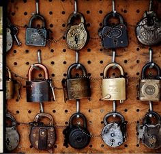 there are many padlocks hanging on the wall