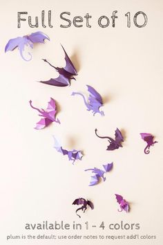 purple origami dragon decorations on a white background