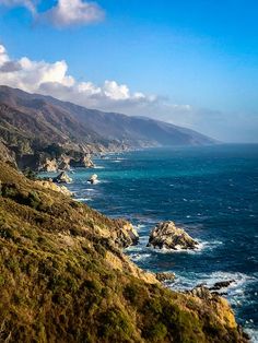 a scenic view of the ocean and mountains