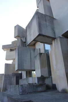 an abstract concrete building with steps leading up to it