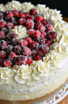 a cake with white frosting and raspberries on top