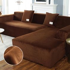 a living room with a brown couch and coffee table in front of a fireplace area