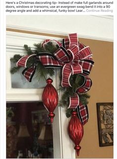 a red and black bow hanging from the side of a door with christmas decorations on it