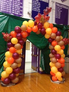 an arch made out of balloons and leaves