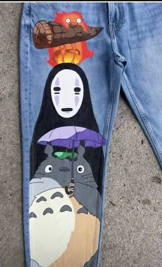 a pair of jeans with cartoon characters painted on them