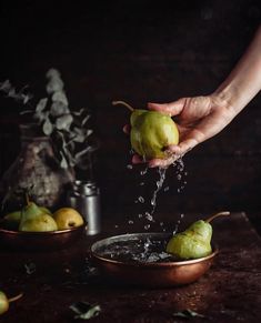 someone is sprinkling water on some pears