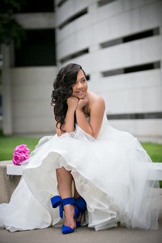 a woman in a wedding dress sitting on a bench