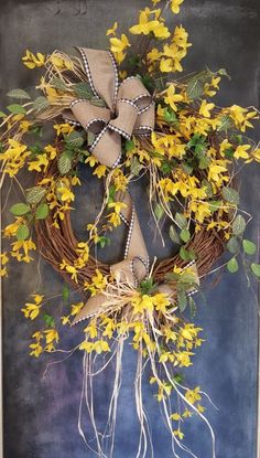 a wreath with yellow flowers and green leaves