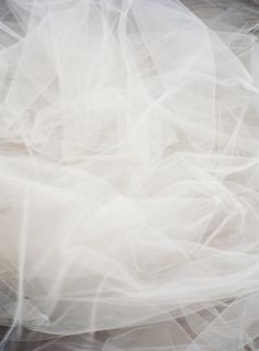 an abstract photograph of white fabric on the ground