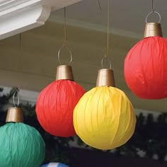 four paper lanterns are hanging from the ceiling