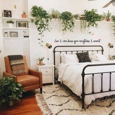 a bed room with a neatly made bed and lots of plants on the wall above it