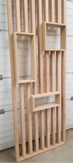 a large wooden shelf sitting in front of a white wall with shelves on each side