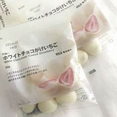 three packets of white chocolate covered strawberries in japanese writing on the front and back