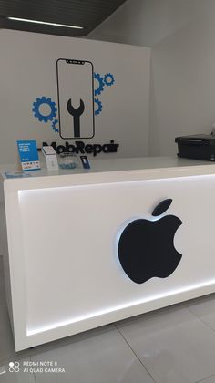 an apple store front desk with the logo on it's back and sidewall