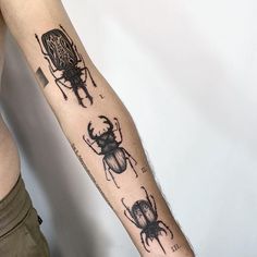 a man's arm with some tattoos on it and an antelope in the middle