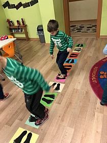 two young boys are playing on the floor