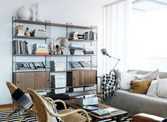 a living room filled with furniture and bookshelves