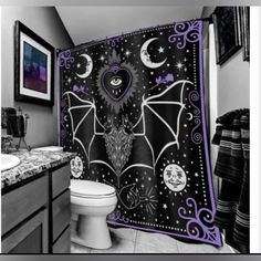 a bathroom with a bat themed shower curtain