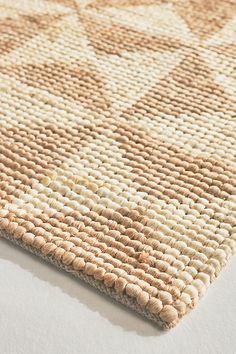 a beige and white area rug on top of a table