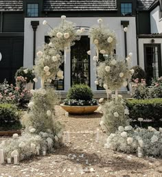 an outdoor ceremony with white flowers and candles