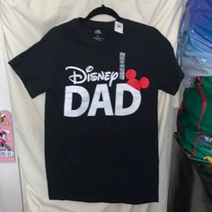 Disney Dad Shirt. Measurements Shown In Pics. Sz Small Men's Mom And Dad Disney Shirts, Black Disney T-shirt For Disney Trips, Casual Black Shirt For Disney Trips, Black Mickey Mouse Shirt For Disney Fan Events, Black Pre-shrunk T-shirt For Disney Trips, Black Shirt With Character Print For Disney Fan Events, Black Disney Short Sleeve Shirt, Black Mickey Mouse Tops For Disney Events, Black Mickey Mouse Top For Disney Fan Events