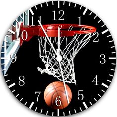 a clock with a basketball going through the hoop on it's face and numbers