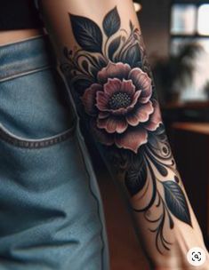 a woman's arm with a flower tattoo on the left side of her arm