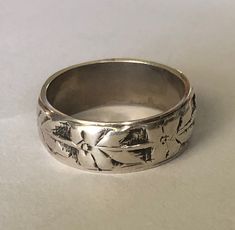 Vintage artisan crafted, hand forged sterling silver band ring.  This one has been well loved, and the pattern has softened with aged.  There is not sterling hallmark, but I have acid tested this ring and it is authentic.  It looks to me like a southwestern Native American made piece.  Would make a  beautiful wedding band, thumb ring for her or just a great everyday ring.  Very pretty and distinctive. Size 12.  9 grams silver.  8.5mm wide. To see all of my rings: https://www.etsy.com/shop/DamselFarmVintage?section_id=35471969 I sell vintage items but do not list anything (knowingly) that is overly worn or damaged.  Happy customers are important to me so please contact me with any issues that might come up with your order. Shipping overages for combined orders will be refunded. This item is Mens Sterling Silver Rings, Vintage Mens Ring, Weird Rings, Wide Silver Ring, Beautiful Wedding Bands, Jewelry Mens, Wide Band Ring, Everyday Ring, Motif Vintage