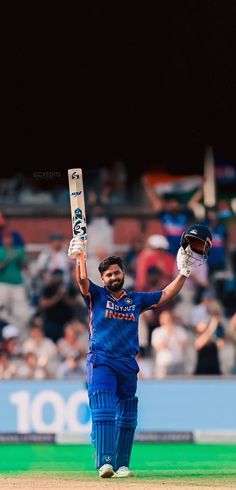 a man holding a cricket bat in his hands