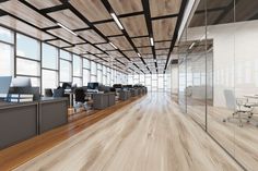 an empty office with wooden floors and glass walls