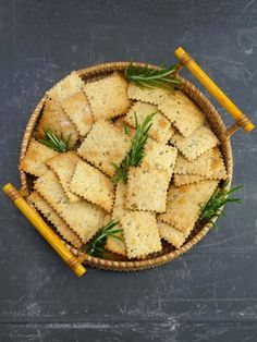 crackers in a basket with rosemary sprigs