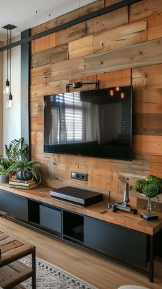 a flat screen tv mounted to the side of a wooden wall in a living room