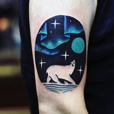 a man with a tattoo on his arm has a polar bear and stars in the sky