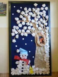 this is an image of a snowman and tree made out of paper mache