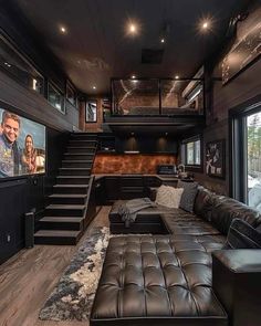 a living room filled with furniture and a flat screen tv mounted to the side of a wall