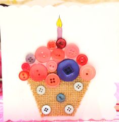 a card with buttons and a cupcake on it