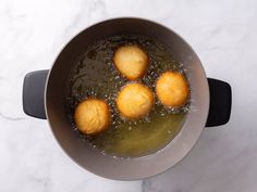 some food is cooking in a pot on the stove top with boiling water and oil