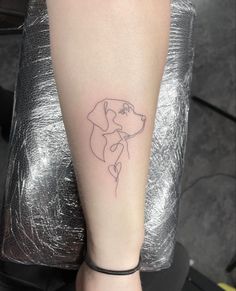 a small dog tattoo on the left arm