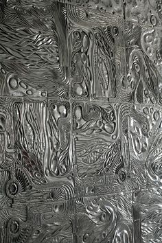 an abstract metal surface with many different patterns