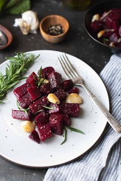 a white plate topped with beets and potatoes