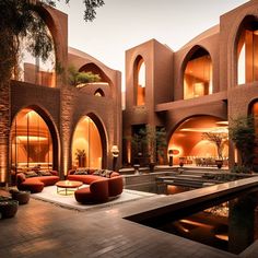 an outdoor area with couches, tables and water feature in the center surrounded by brick arches