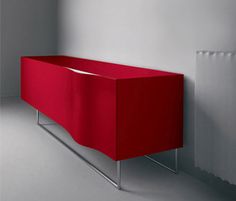 a red sideboard sitting next to a radiator